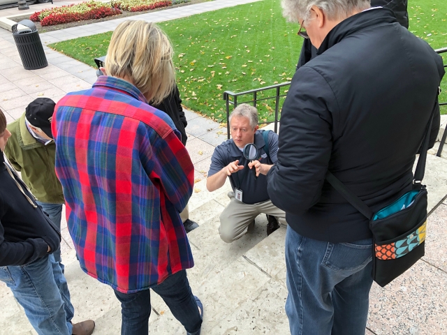 A geologist points out prominent fossils in the Ohio Statehouse buildings stones. Photo Credit: ODNR.