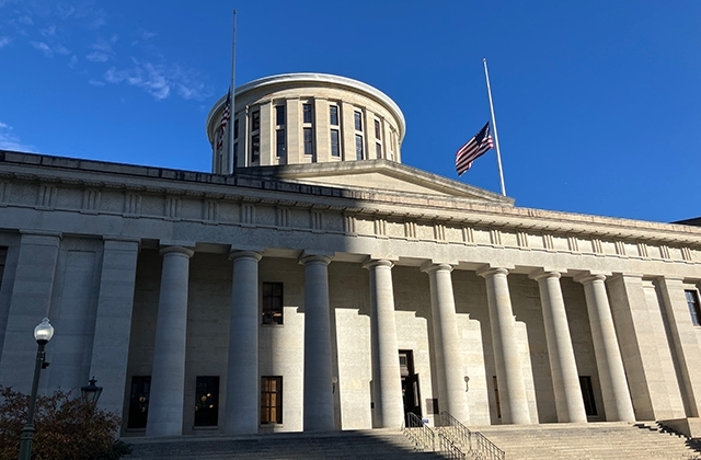 Ohio Statehouse with flags at half-staff.